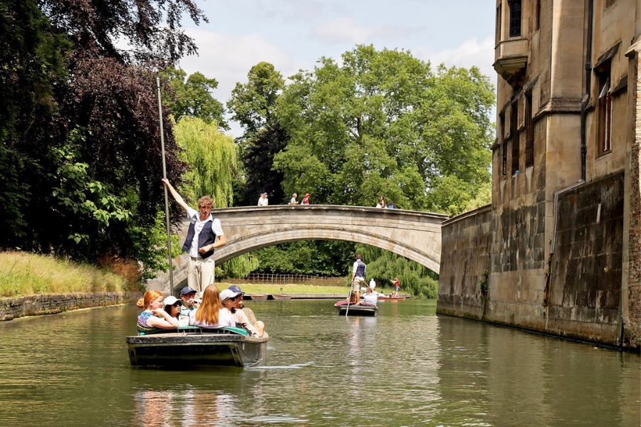 Two Boats Punting Along the River Cam in Cambridge.