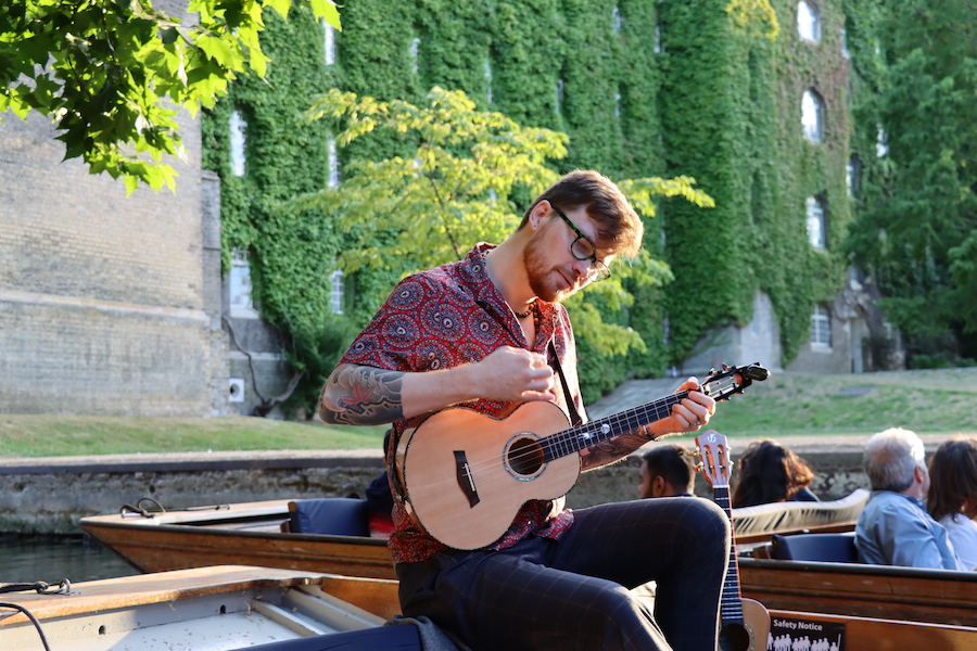 Singer in front of St Johns College on a chauffeured punt tour